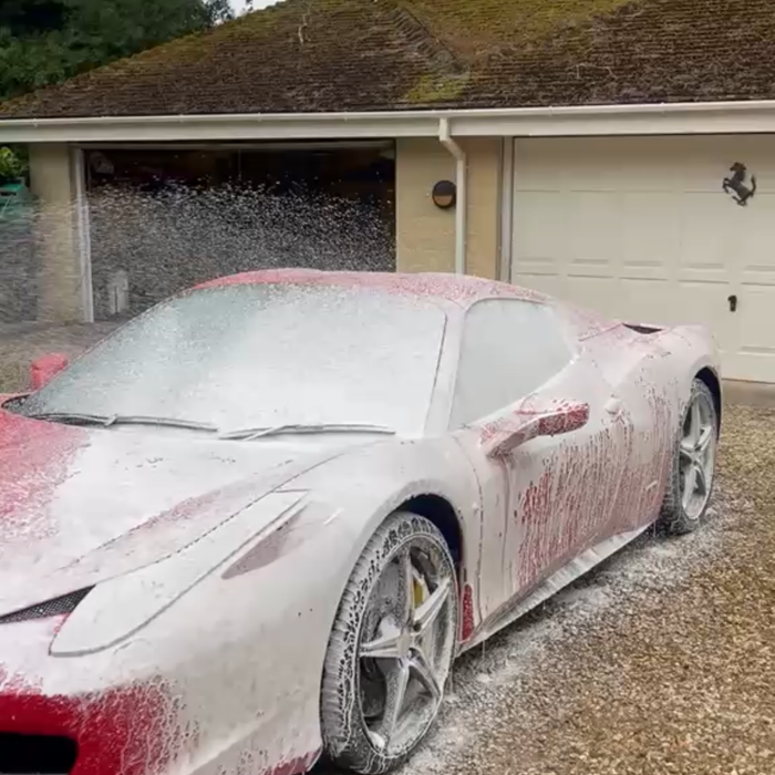 Ferrari 458 before exterior clean — covered in snow foam during hand wash